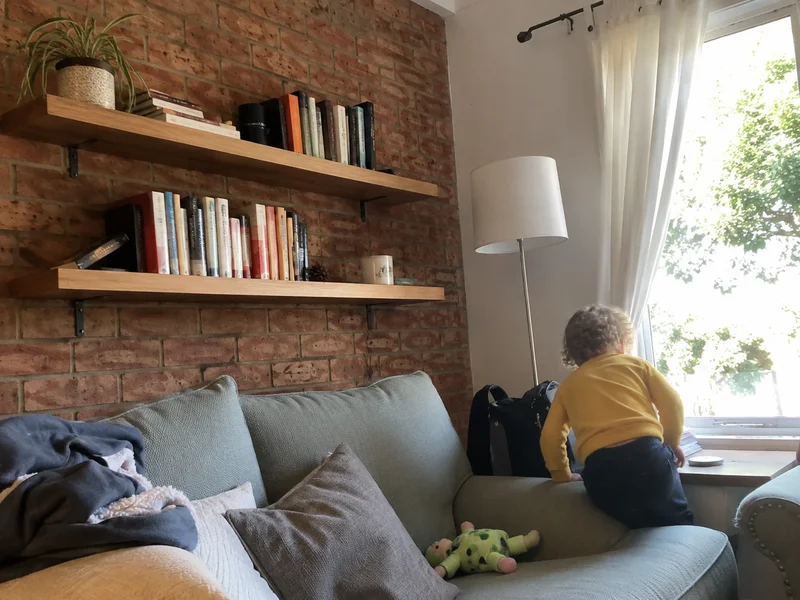 Floating timber shelves installed level on a brick wall