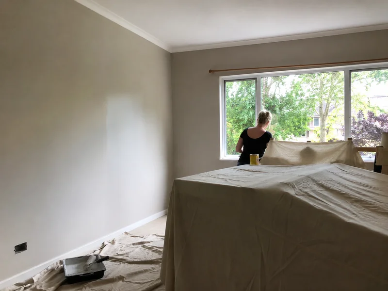 Freshly repainted bedroom with cut-in edges around the cornice