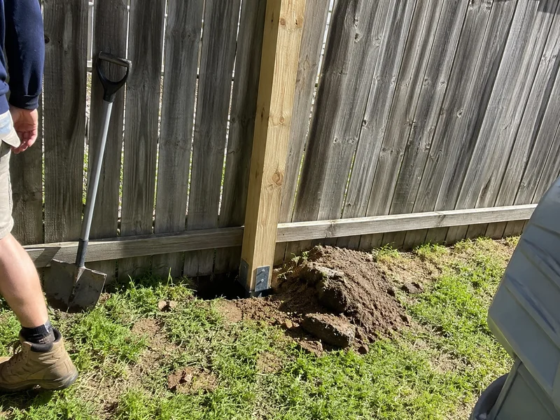 Replacement fence post spliced in beside existing palings