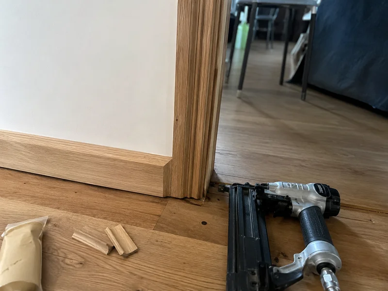 Newly fitted skirting and architrave around a doorway