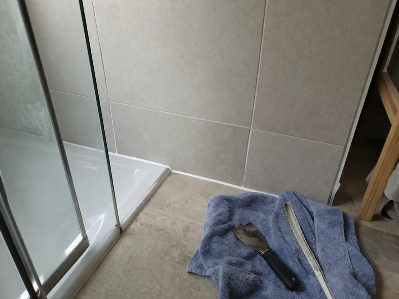 Shower corner silicone stripped and replaced with a clean bead