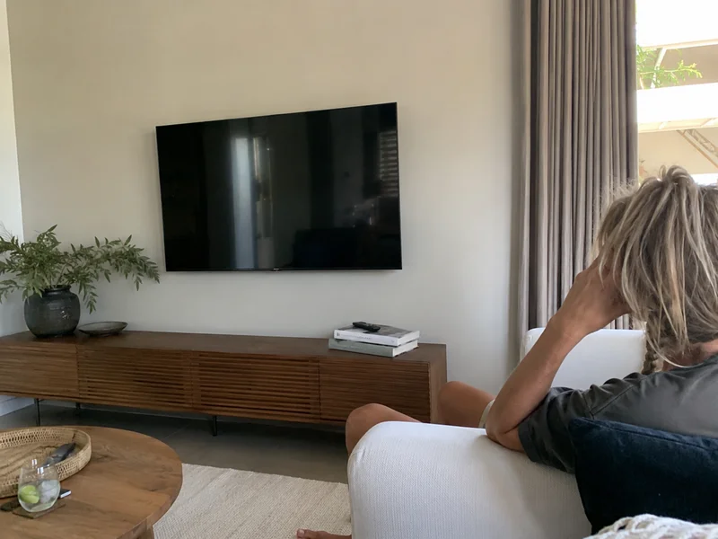 Wall-mounted television with cables run out of sight