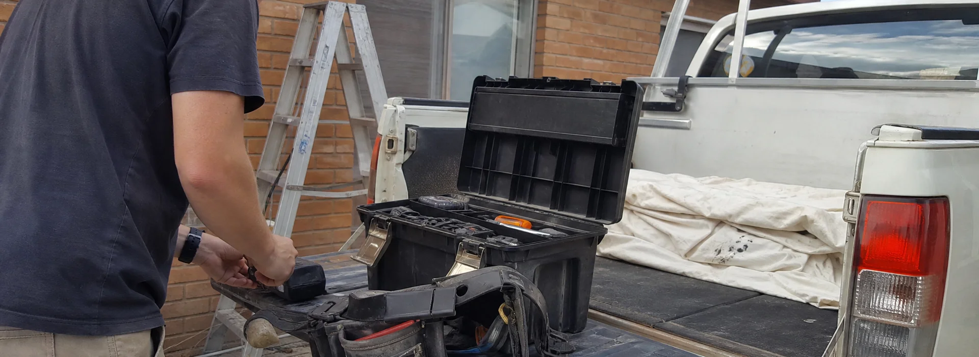 Handyman tools laid out on the tailgate of a work ute