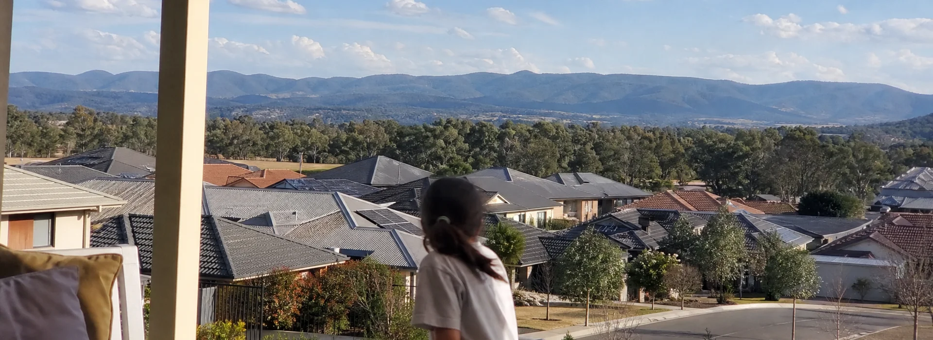 View over Canberra suburban rooftops with the Brindabella ranges behind